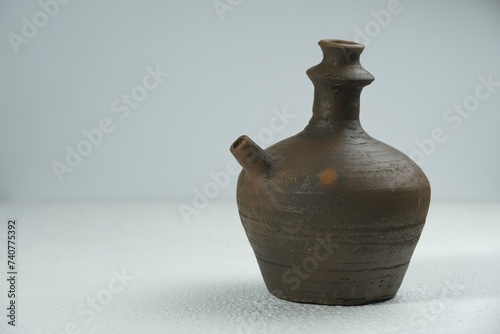 Isolated Kendi on a white background, kendi is the name of a traditional Javanese Indonesian drinking pot made of clay. photo