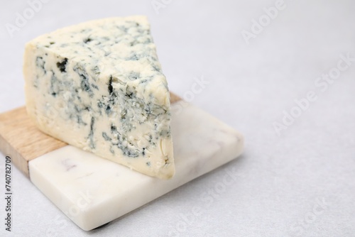 Tasty blue cheese on light table. Space for text