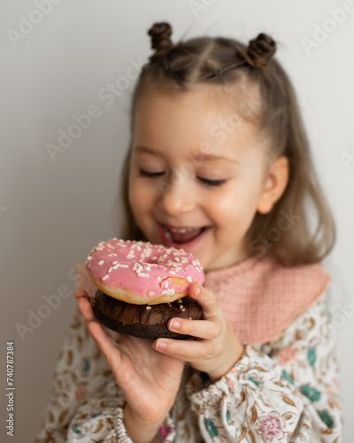 little girl eating  donut