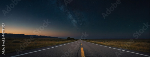 Isolated country road with an empty asphalt surface, framed by the tranquil night sky.