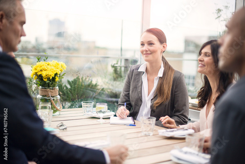 Businesswoman during meeting at restaurant with colleagues photo