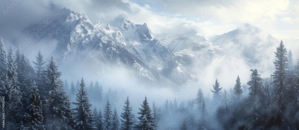 Majestic snow-capped mountain with a backdrop of dense pine trees and fluffy clouds