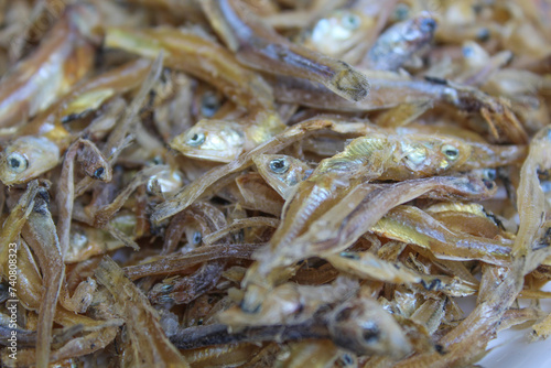 Background texture of dried anchovy fish, uncooked. Preserved with salt
