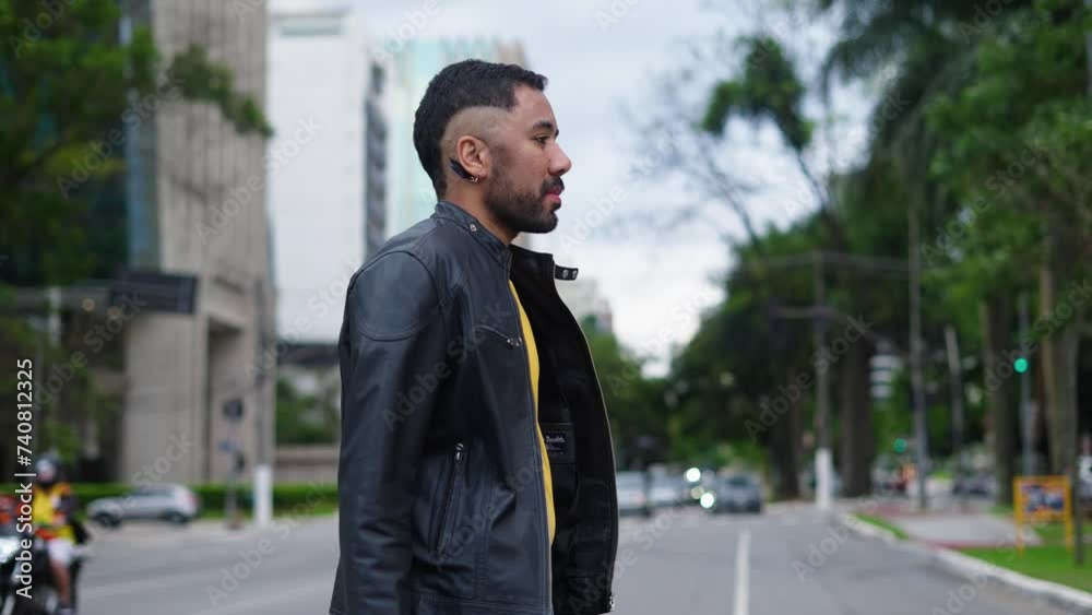 Portrait confident queer fashion man walking in stylish outfit outdoors. Thoughtful man crossing street outdoors at city. Young business gay man at street.
