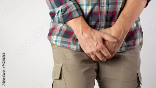 A man suffers from pain in the pelvic organs, close-up. photo