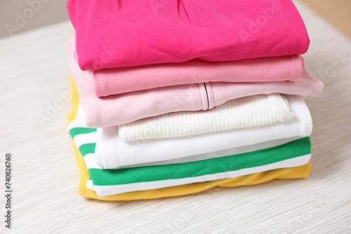 Stack of folded clothes on table, closeup