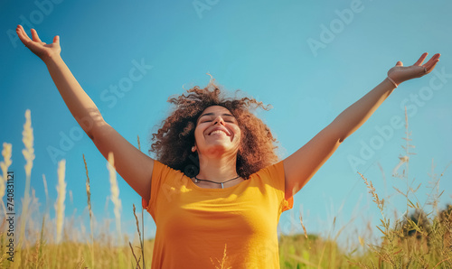 happy carefree woman with raised hands, joy and freedom concept