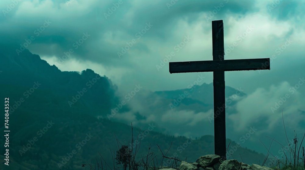 The Cross of Jesus stands before a mountain range embodying strength and steadfastness The Cross of Jesus stands before a mountain range embodying strength and steadfastness