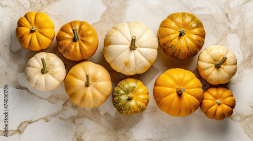 A group of pumpkins on a light yellow color marble