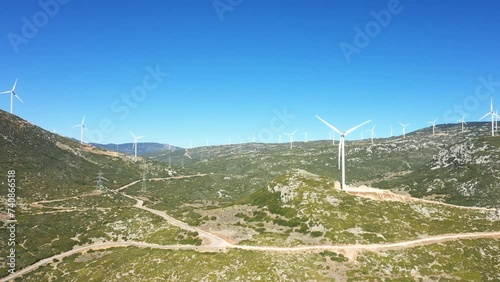 A huge field of wind turbines in Europe, central Greece, towards Thisbe, in summer, on a sunny day. photo