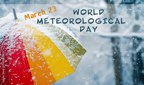 Rainbow umbrella under heavy snow in park. World meteorological day photo