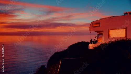 Camper rv camping on beach sea shore at sunrise. Adventure, travel with mobile home to Spain in wintertime.