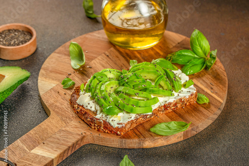 Delicious wholewheat toast with avocado, cream cheese and chia seeds on a wooden board. top view. copy space for text