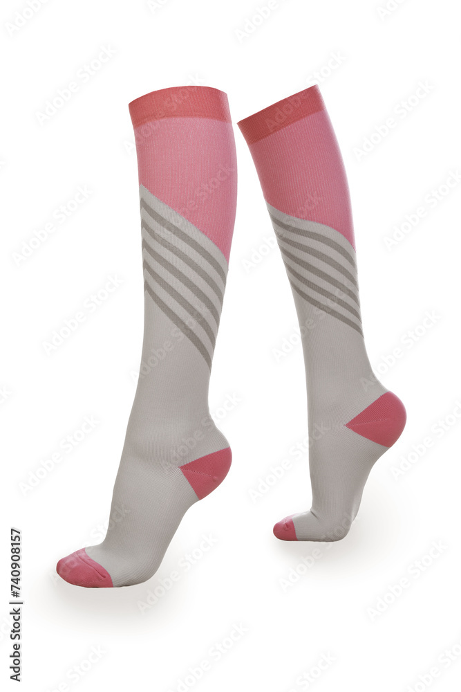 Close-up shot of a pair of high compression socks. Pink and gray medical compression stockings for the prevention of varicose veins are isolated on a white background. Side view. Close-up shot of a pair of high compression socks. Pink and gray medical compression stockings for the prevention of varicose veins are isolated on a white background. Side view.