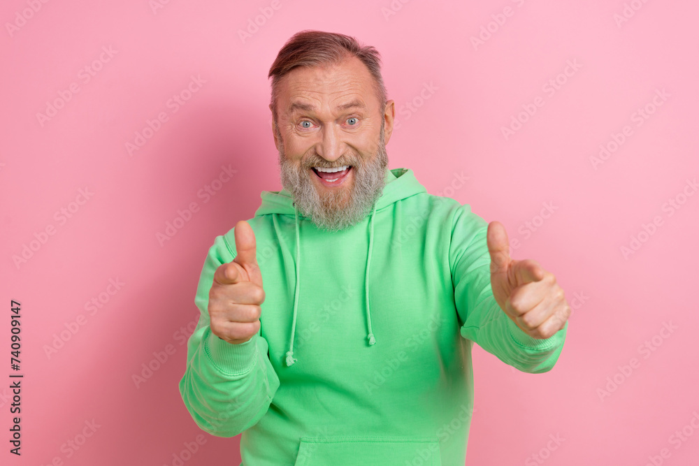 Photo portrait of handsome senior man point you excited hey wear trendy green garment isolated on pink color background Photo portrait of handsome senior man point you excited hey wear trendy green garment isolated on pink color background