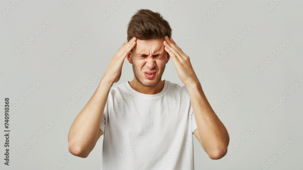 man in visible distress, with his eyes tightly shut and hands pressed against his temples, suggesting he is experiencing a severe headache or migraine. man in visible distress, with his eyes tightly shut and hands pressed against his temples, suggesting he is experiencing a severe headache or migraine.