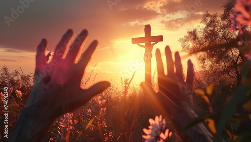Silhouette of hands on the background of the cross and sunset photo