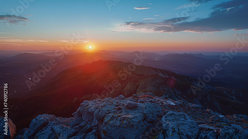 the sun is setting over a mountain range