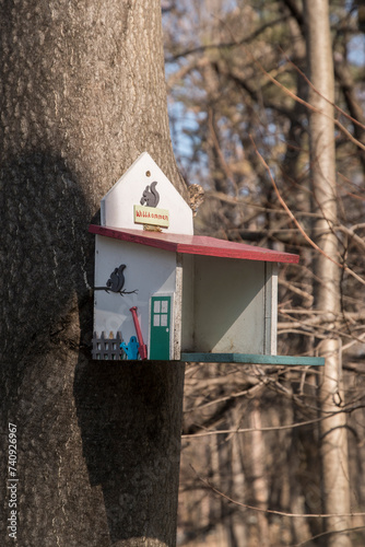 A bird shelter house hung on tree in park