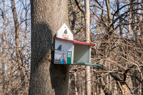 A bird shelter house hung on tree in park
