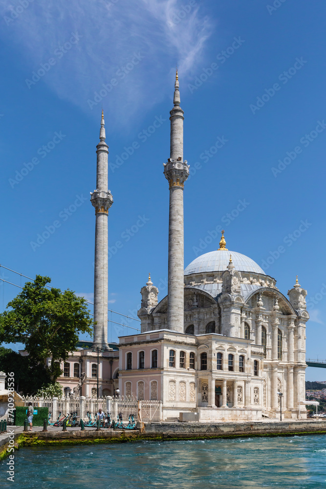 Ortakoy Mosque on the banks of the Bosphorus on summer day. Amazing masterpiece of Ottoman baroque, XIX century. Tourism or architecture concept. June 16, 2022. Istanbul, Turkey (Turkiye)