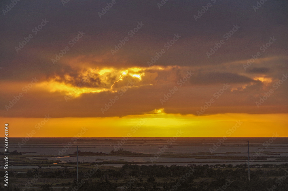 Idyllic scenic nature landscape scenery in Mississippi River delta with marsh, fisher boats, wildlife birds and animals, oil towers and horizon views