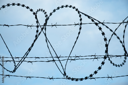 barbed wire Fidget-Alligator against a blue sky photo
