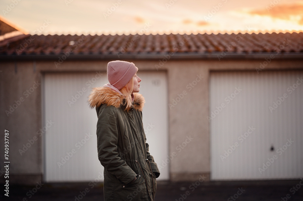 Reflective Young Woman Looking at Sunset in Urban Setting