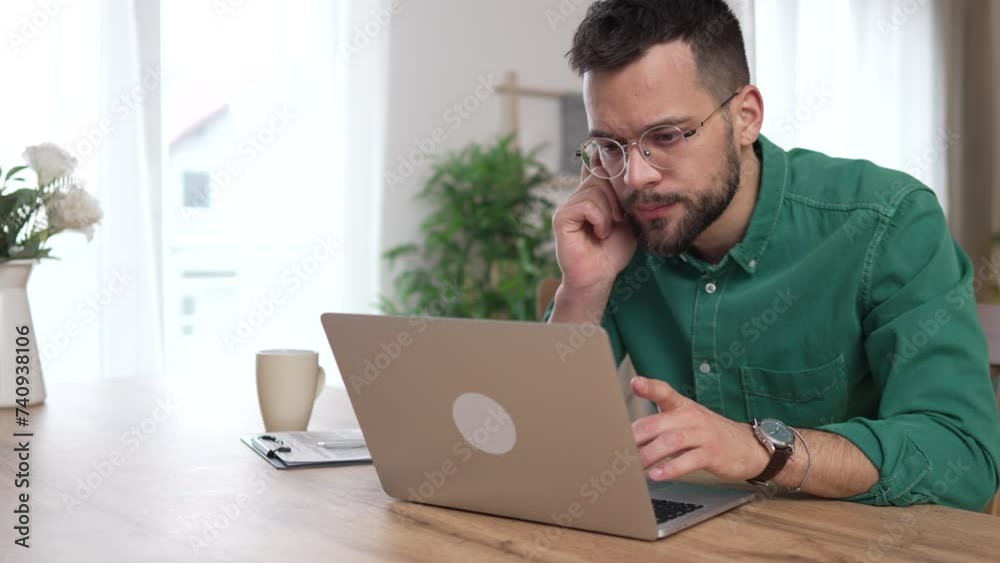 man adult caucasian WITH BEARD AND EYEGLASSES work on laptop at home man adult caucasian WITH BEARD AND EYEGLASSES work on laptop at home