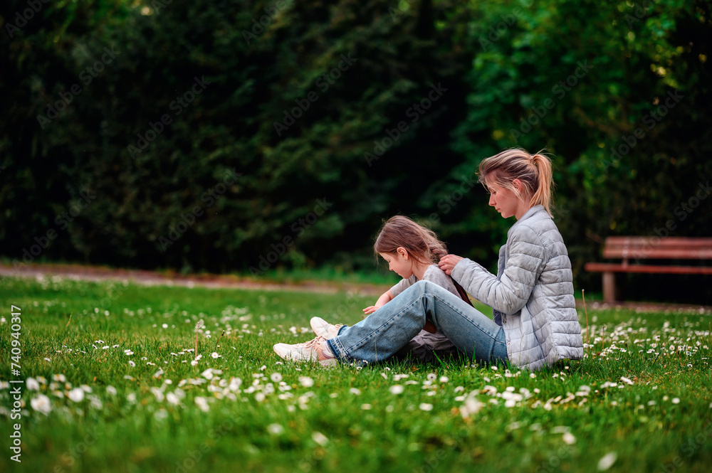 Tender moment between mother and daughter in a serene park setting Tender moment between mother and daughter in a serene park setting