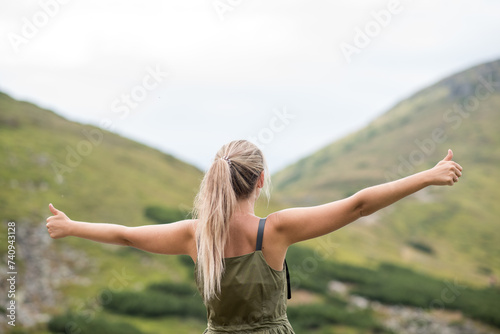 Beautiful young woman in the mountains.