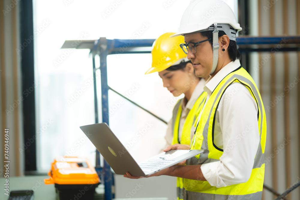Construction engineer with technician designer team working build site inspect for interior renovate in industry workshop building with floor plan. Construction engineer with technician designer team working build site inspect for interior renovate in industry workshop building with floor plan.