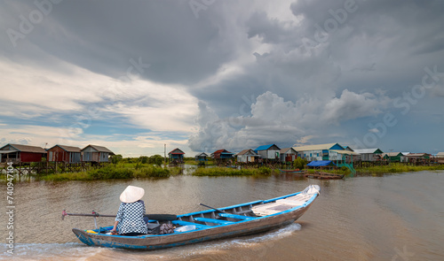 Tonle Sap lake, Siem reap Province, Cambodia. Fisherman in his boat, Floating village of Kompong Phluk, Cambodia. photo