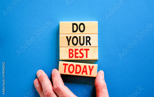 Do your best today symbol. Concept words Do your best today on beautiful wooden block. Beautiful blue table background. Businessman hand. Business motivational do your best today concept. Copy space photo