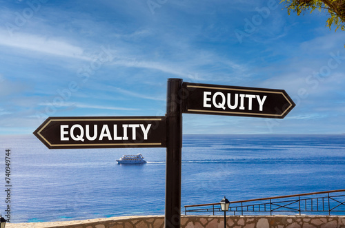 Equity or equality symbol. Concept word Equity or Equality on beautiful signpost with two arrows. Beautiful blue sea sky with clouds background. Business and equity or equality concept. Copy space.