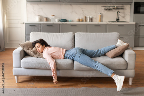 Woman napping on couch in daylight photo