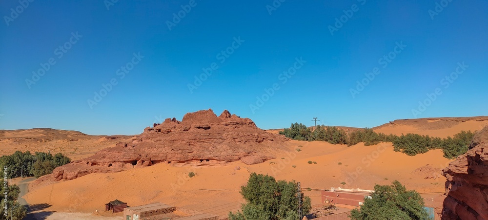 the remains of Ksar d'Ighzer, ruins of ancient stone and red clay houses, a village in the middle of the desert in the town of Timimoun, Algeria the remains of Ksar d'Ighzer, ruins of ancient stone and red clay houses, a village in the middle of the desert in the town of Timimoun, Algeria