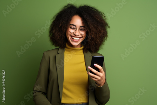 Happy African American woman with phone on Olive studio background