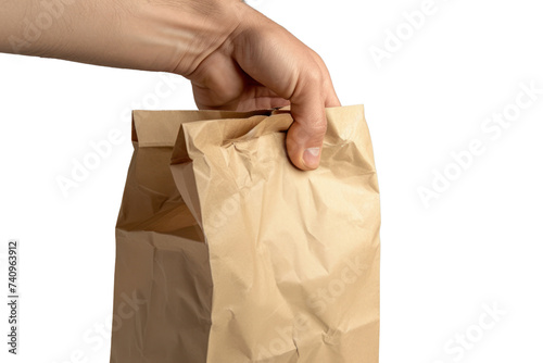 His right hand holds a brown paper bag. Hand holding a paper bag isolated on transparent background.