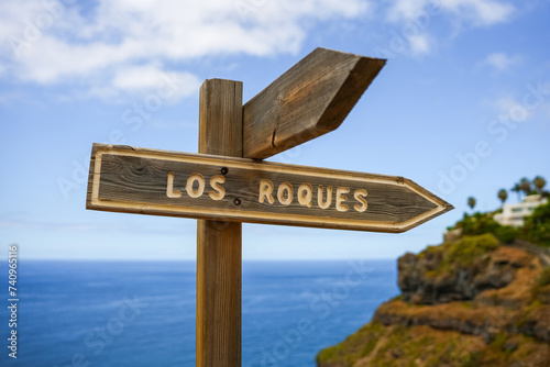 Wooden signpost on which is written Los Roques, Canary Islands, Tenerife Spain