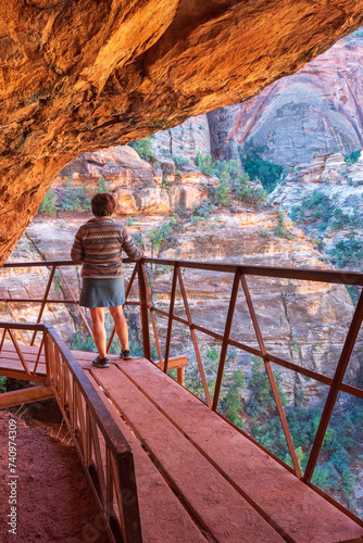 Middle-aged woman taking in the views along the Zion-Mount Carmel Tunnel trail, Zion National Park, Utah.