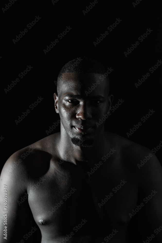 close-up of an African-American man's face on a black background with 90-degree illumination close-up of an African-American man's face on a black background with 90-degree illumination