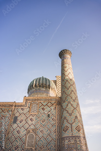 Eastern architecture of buildings, madrasahs, mausoleums and mosques made of brick and mosaic cladding on the facades in the ancient city of Samarkand in Uzbekistan