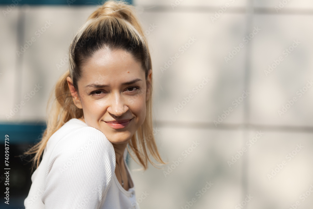 Outdoor portrait of a beautiful city girl with urban background.