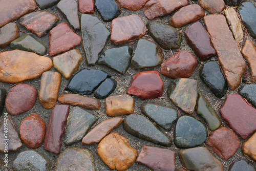 Wet multicolored cobblestone pavement in the city square on a rainy day
