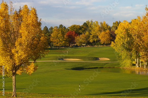 Scenic golf course with trees, grass, and water in the foreground, Denver photo