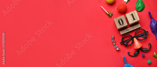 Date 1 APRIL with party decor for Fools' Day celebration on red background