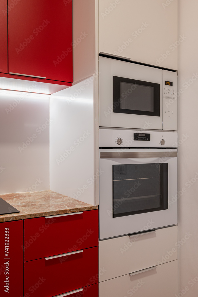 Fototapeta premium Close-Up of Modern Kitchen Appliances Integrated in Cabinetry