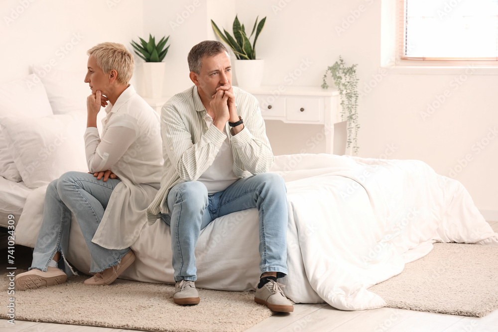 Offended mature couple after quarrel in bedroom Offended mature couple after quarrel in bedroom