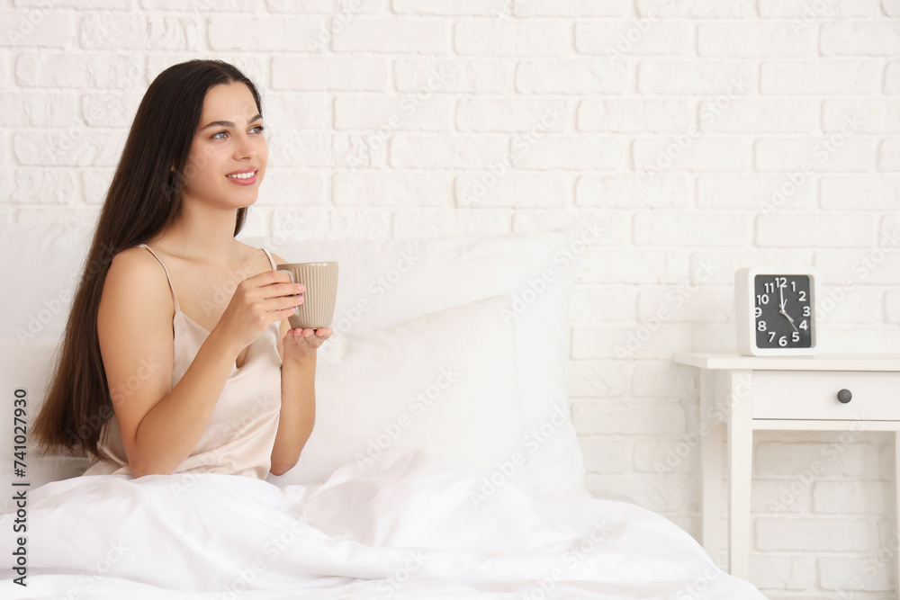 Morning of young woman drinking hot coffee in bed Morning of young woman drinking hot coffee in bed